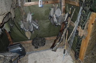 Decoys and shotguns await the dawn in the spartan quarters of the duck blind.
